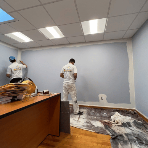 A painter preparing a surface for painting.