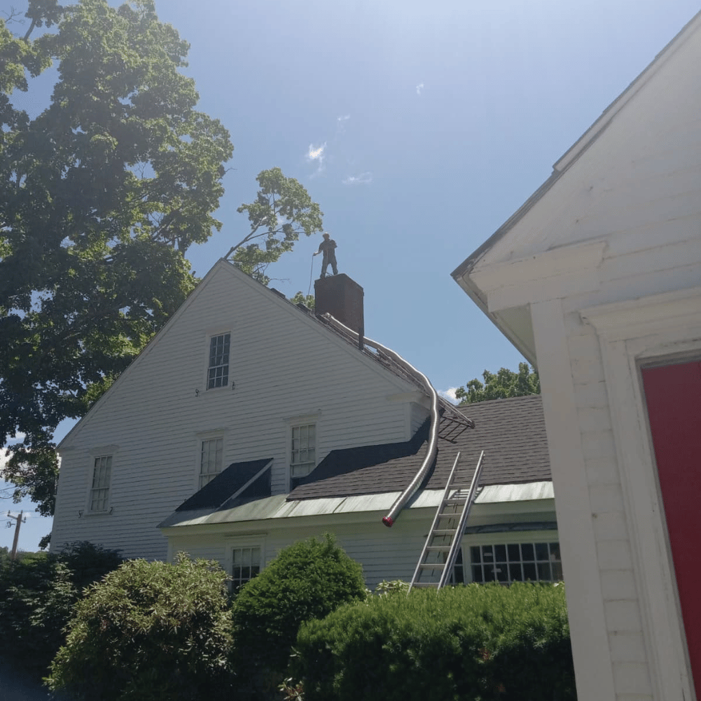 Technician cleaning a chimney
